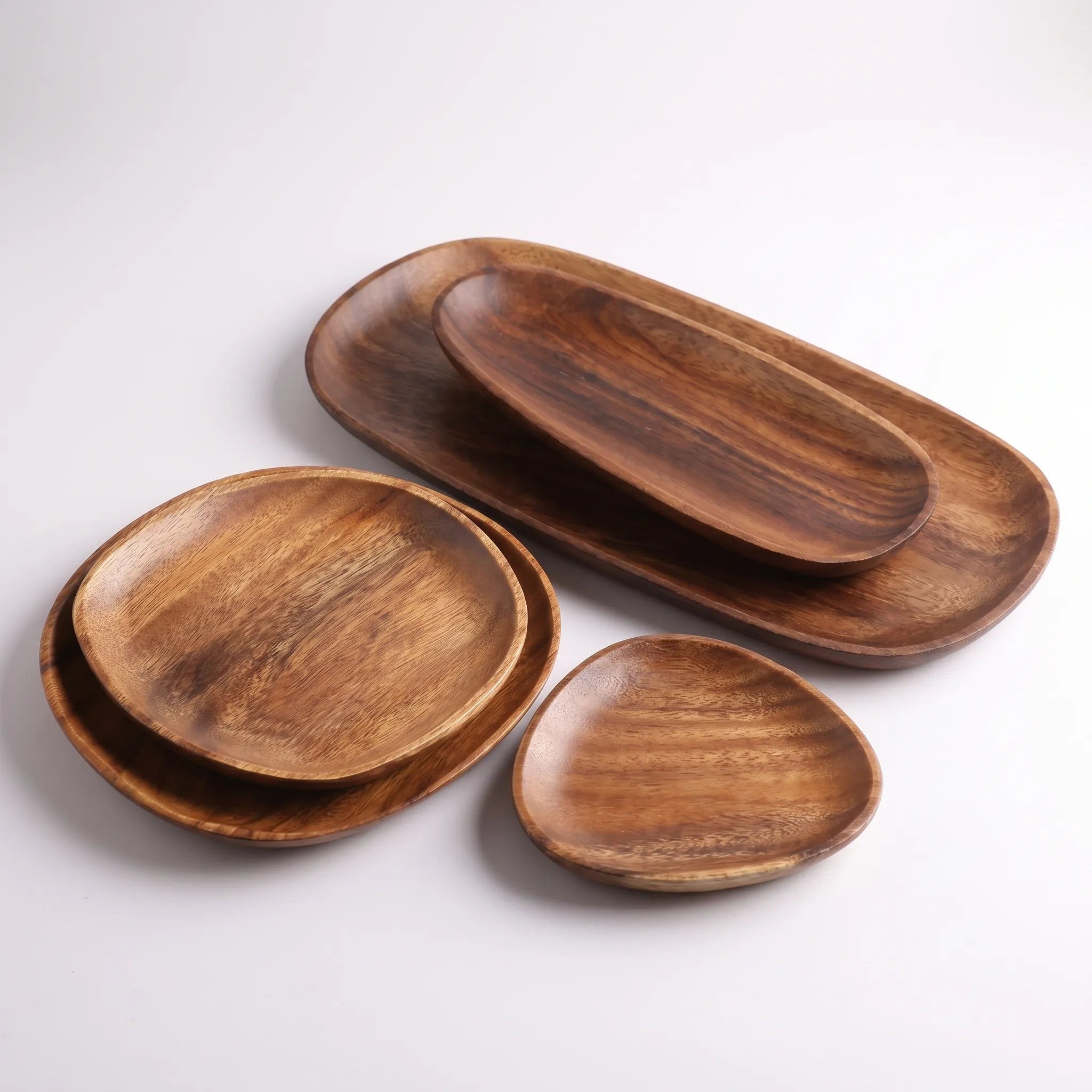 5-Piece Wooden serving Set  For charcuterie and food in a white studio. 