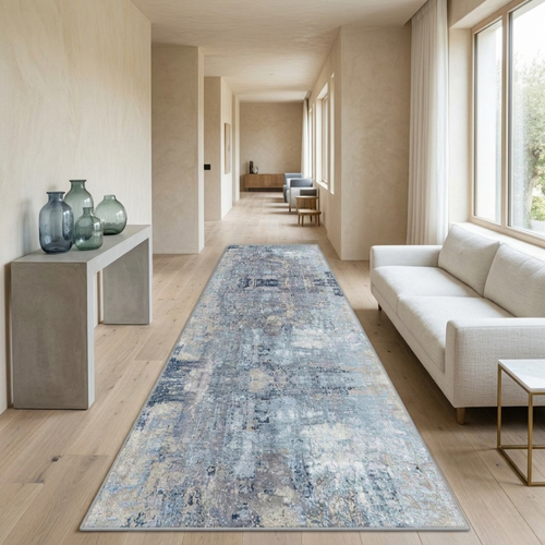 Long, patterned rug in a modern living room with neutral decor.