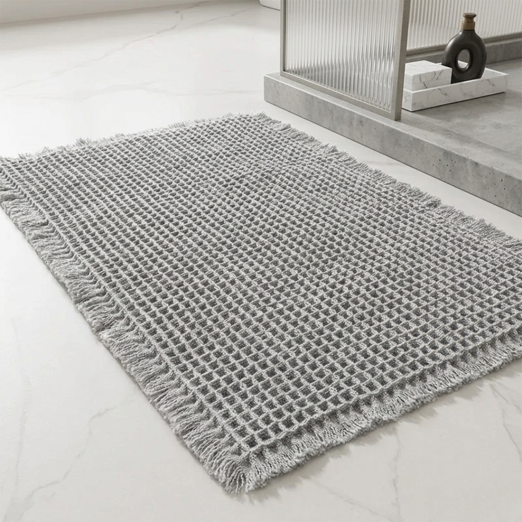 Gray textured rug on a light wooden floor