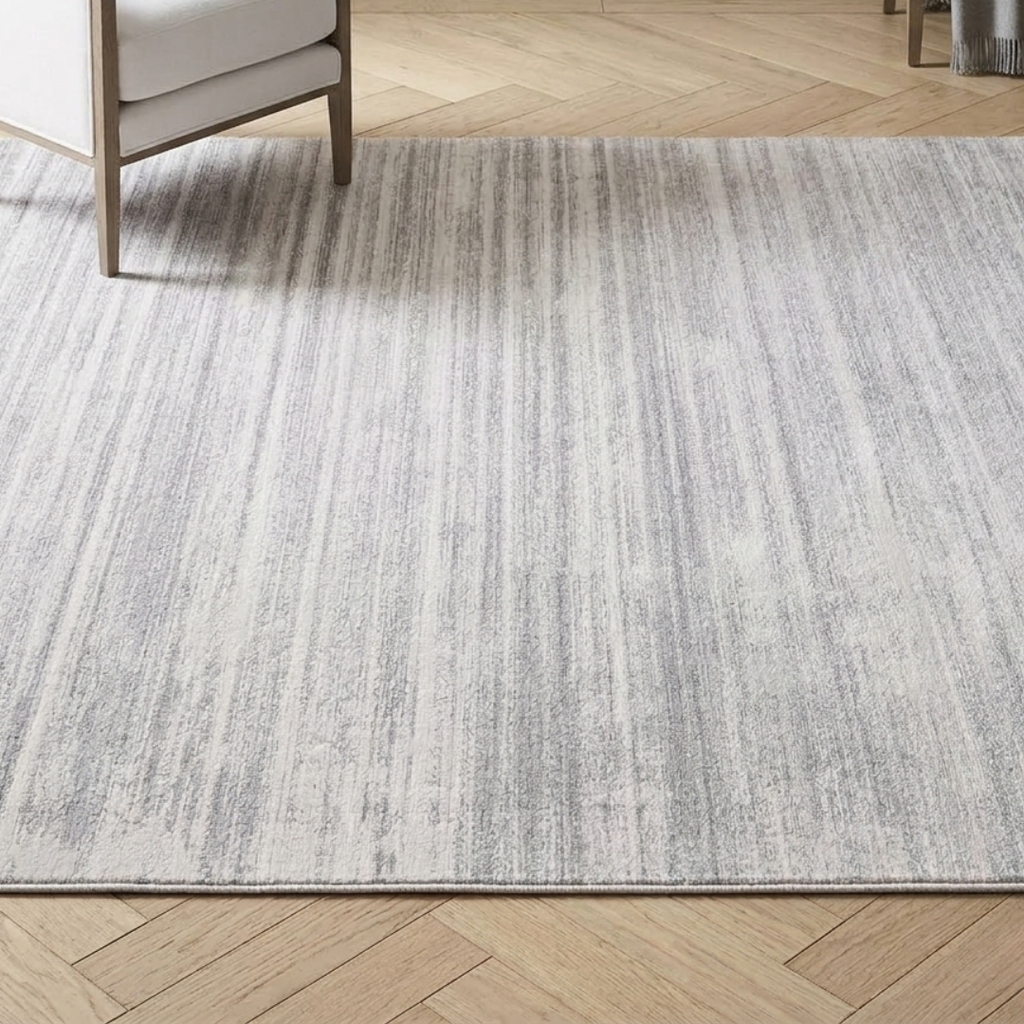 Gray area rug on a wooden floor