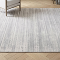Gray area rug on a wooden floor