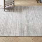 Gray area rug on a wooden floor