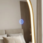 Gold-framed mirror with power symbol light on a neutral background