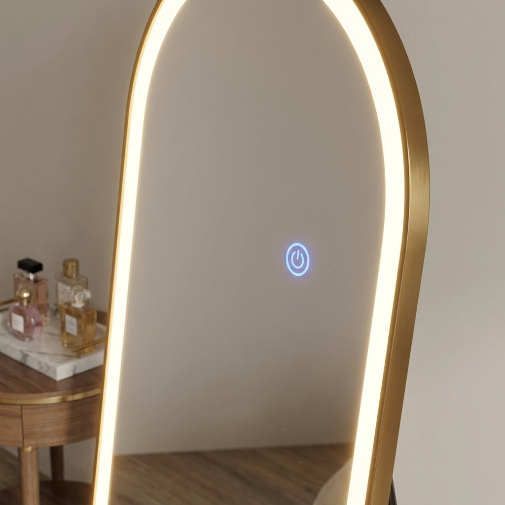 Gold-framed mirror with LED lighting on a neutral background