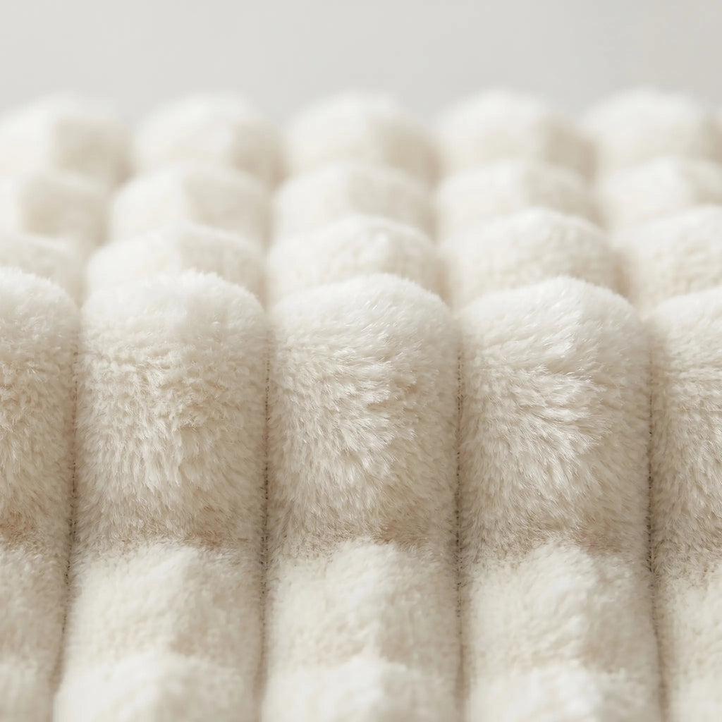 Close-up of fluffy white yarn on a light gray background