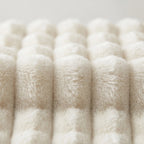 Close-up of fluffy white yarn on a light gray background