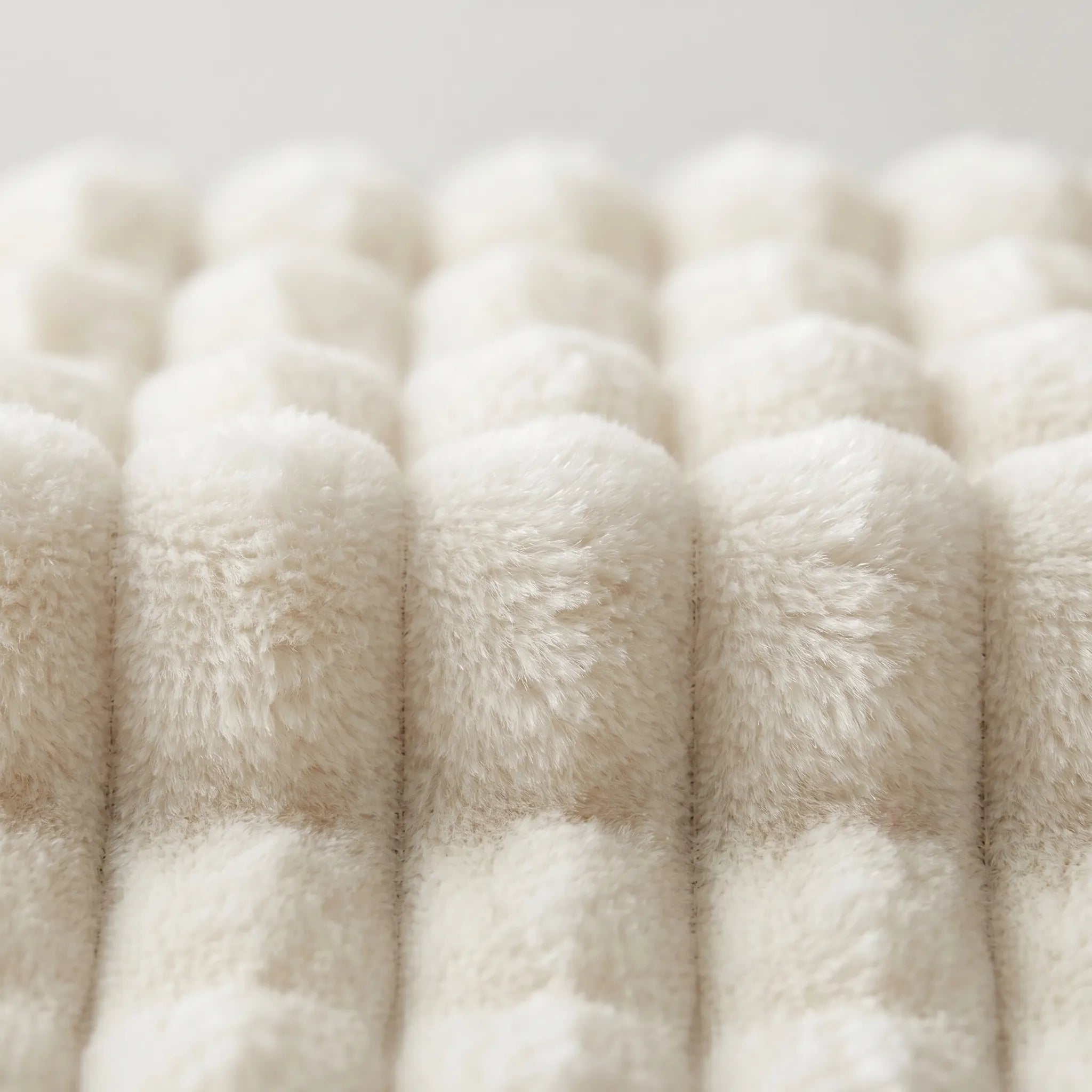 Close-up of fluffy white yarn on a light gray background