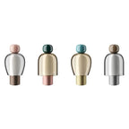 Set of four decorative bottles with multicolored caps on a white background