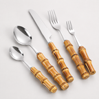 Five-piece bamboo handle cutlery set isolated on a white background.