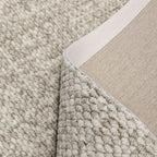 Close-up of a textured beige carpet corner
