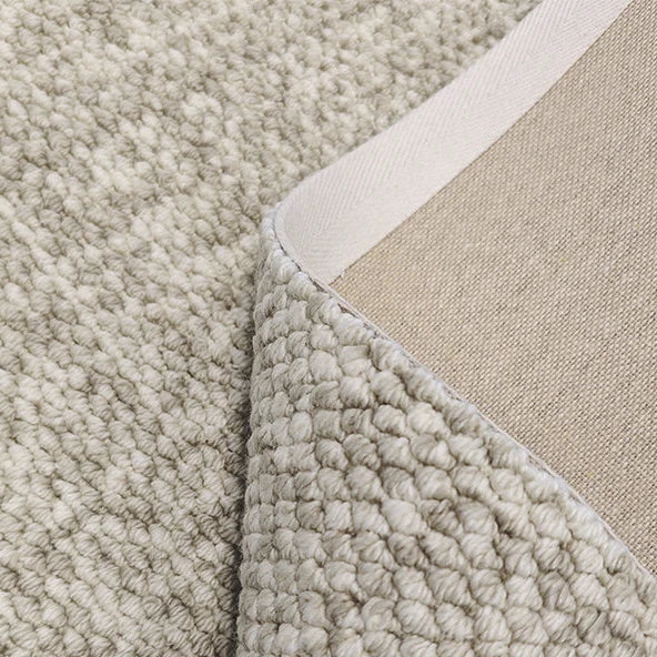 Close-up of a textured beige carpet corner