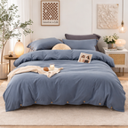 Blue bedding set on a bed in a well-decorated bedroom