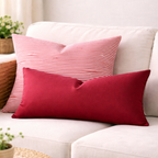 Red and striped cushions on a white sofa with a neutral background