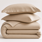 Beige cotton bedding set with two pillows and a duvet on a white background