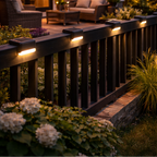 Outdoor deck with string lights, furniture, and plants at night.