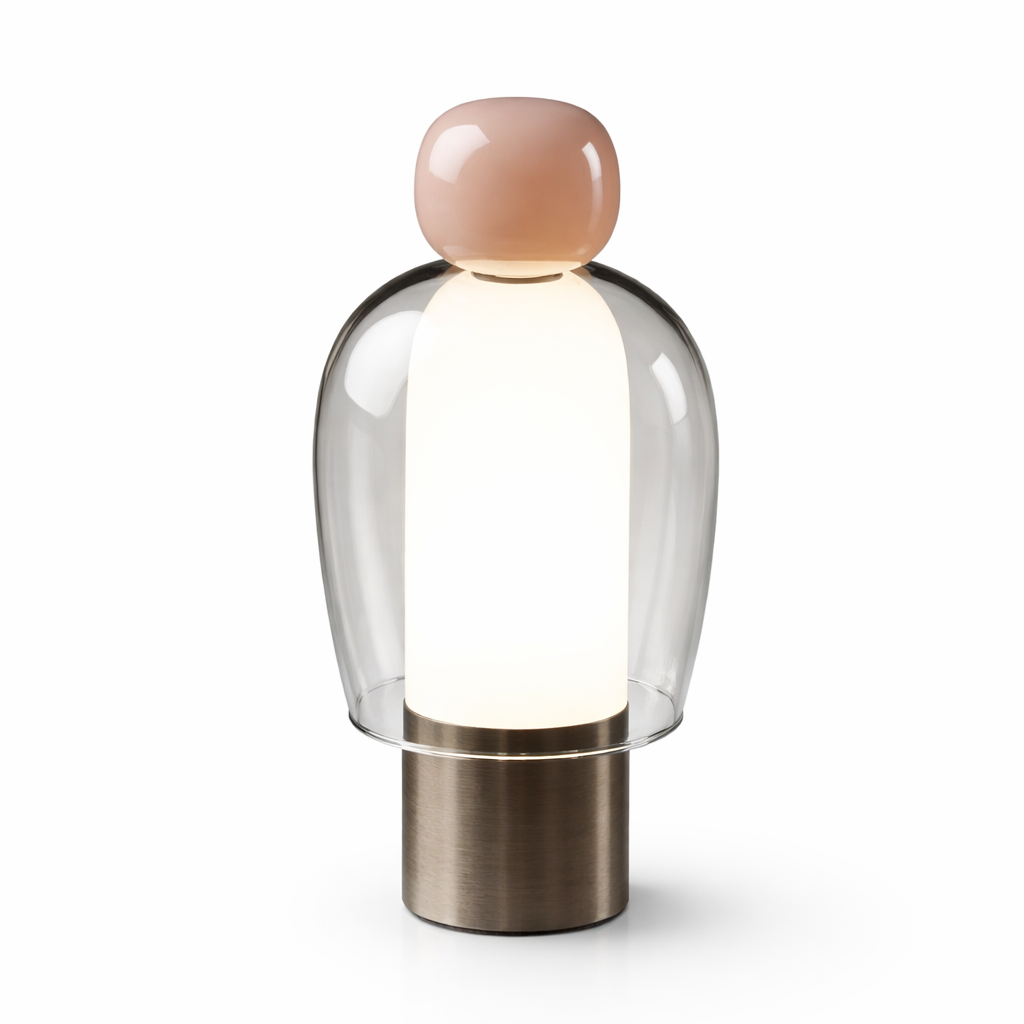 Modern table lamp with a clear glass shade and metallic base on a white background