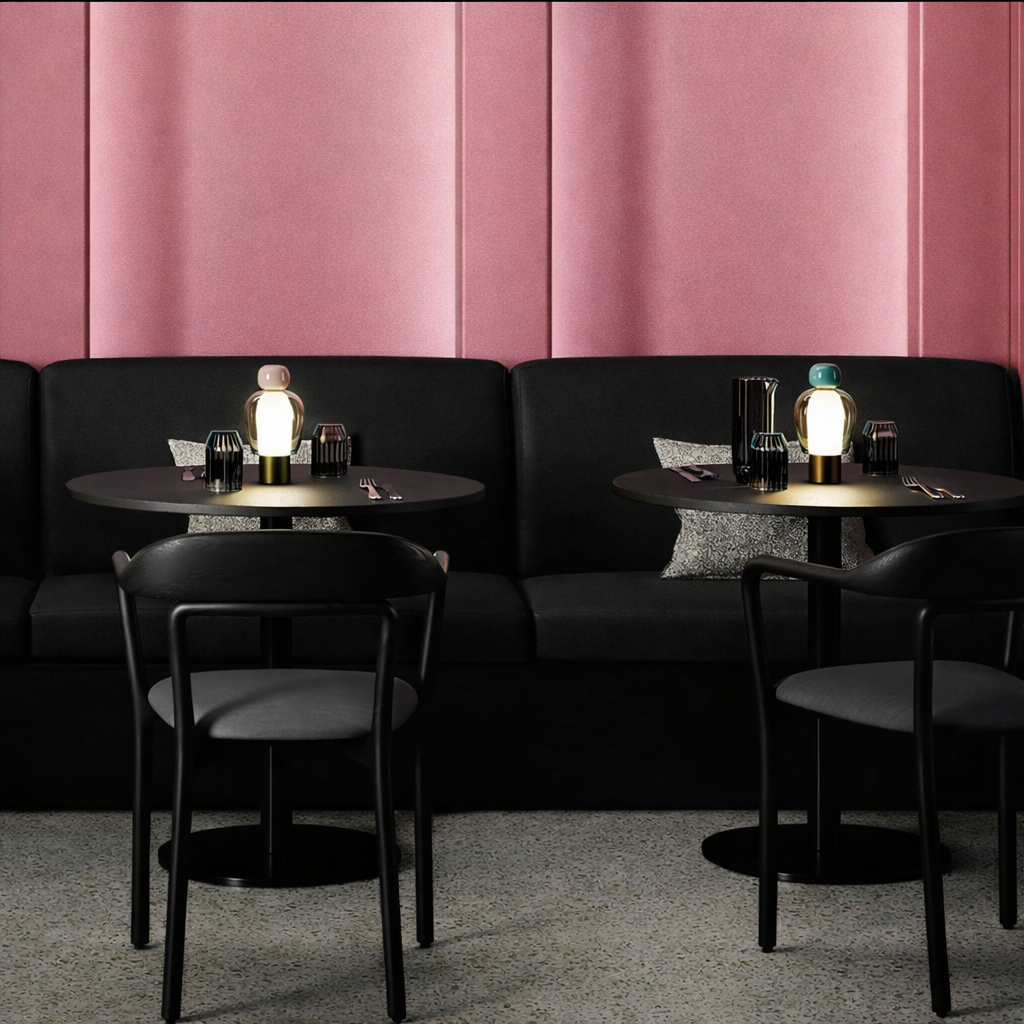 Modern cafe interior with black furniture and pink walls