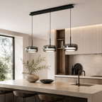 Modern tripple lamp chandelier with tinted glass lamps in a nice modern kitchen.