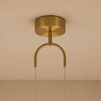 Gold ceiling light fixture on a beige background