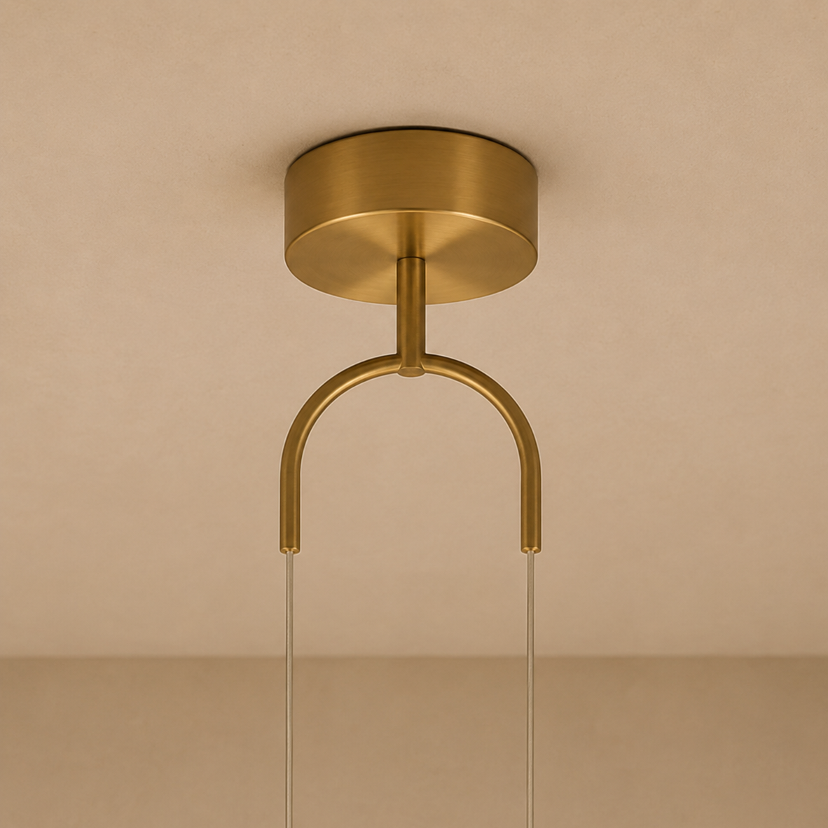 Gold ceiling light fixture on a beige background