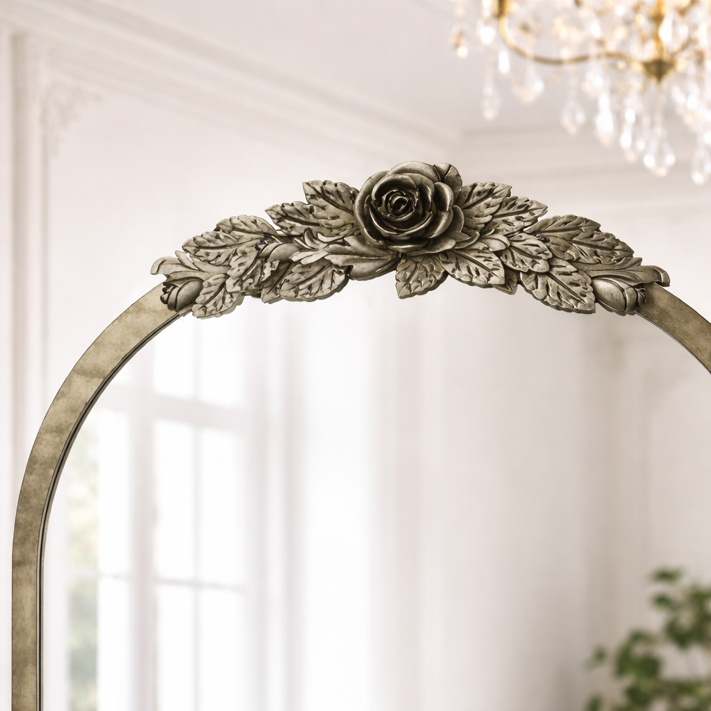 Decorative mirror with floral frame in a room with a chandelier