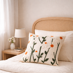 Decorative pillow with floral pattern on a bed in a bedroom setting