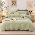 Green bedspread set on a bed in a well-decorated bedroom