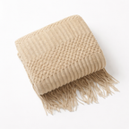 Khaki blanket throw in a white proffesional studio.