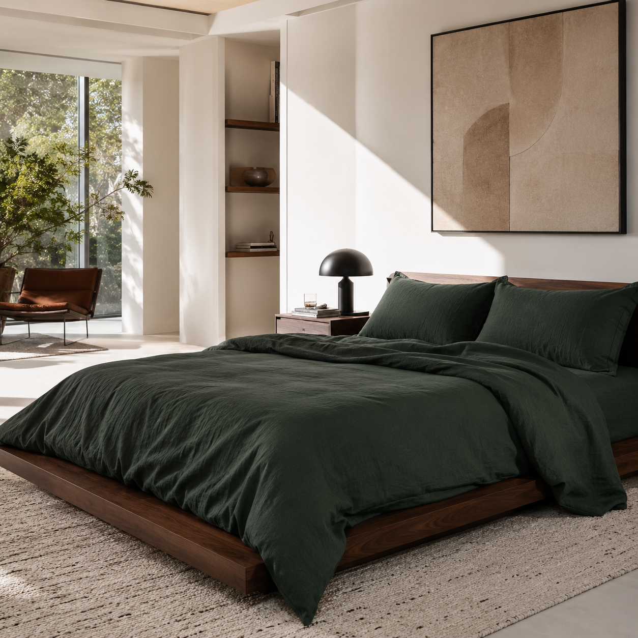 Modern bedroom with dark green linen bedding and a large abstract painting on the wall.