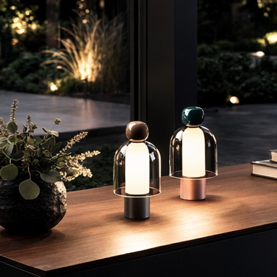 Modern outdoor setting with a wooden table, decorative items, and a view of a garden.