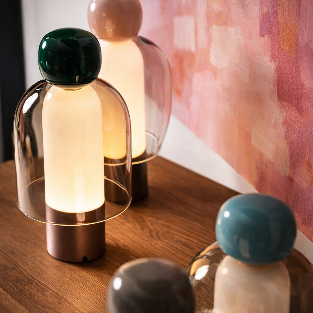 Decorative table lamps with colorful tops on a wooden surface.