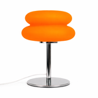 Orange lamp with a chrome base on a white background
