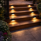 Outdoor patio with string lights, fire pit, and wooden steps illuminated.