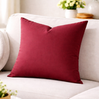 Red pillow on a white sofa with a blurred background