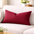 Red pillows on a white couch with a blurred background