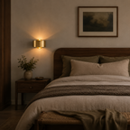 Cozy bedroom with wooden bed, nightstands, and wall sconces.
