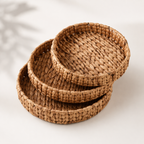 Stack of woven brown baskets on a light background
