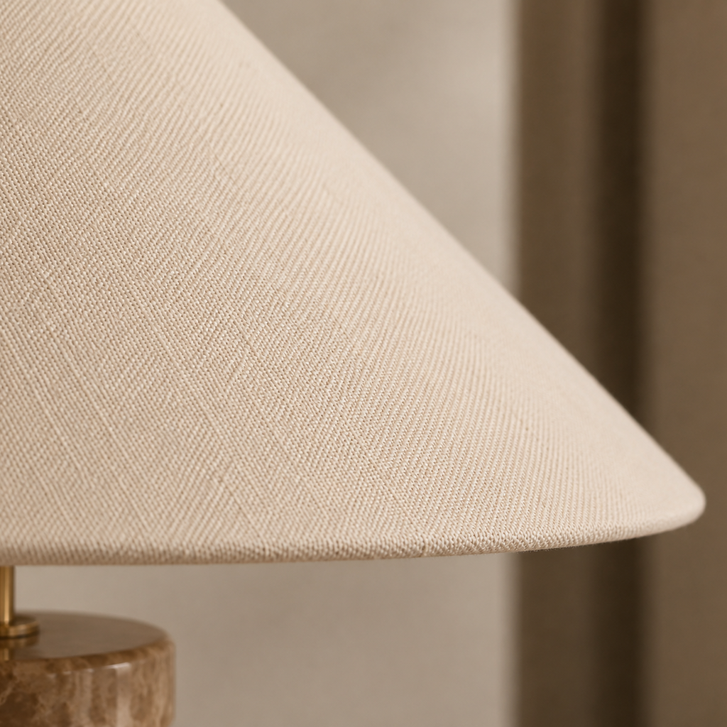 Close-up of a beige lampshade with a blurred background