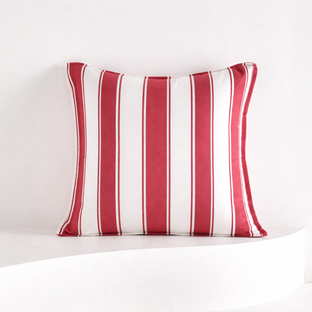 Red and white striped pillow on a white background
