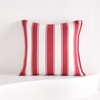 Red and white striped pillow on a white background