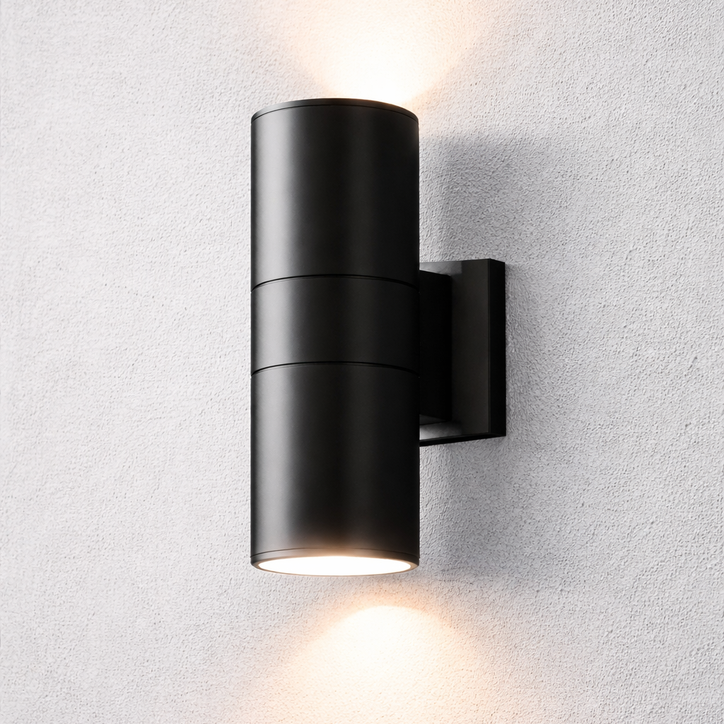 Black wall-mounted outdoor light fixture on a textured white wall